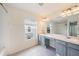 Bright bathroom featuring a double sink vanity and shower/tub combo at 2542 Glenrise Pl, Wesley Chapel, FL 33544