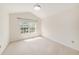 Bedroom featuring neutral walls and carpet with large window for natural light at 2542 Glenrise Pl, Wesley Chapel, FL 33544