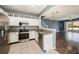 Well-equipped kitchen with stainless steel appliances and adjacent living space at 2542 Glenrise Pl, Wesley Chapel, FL 33544