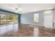 Bright living room with wood floors and screened patio overlooking the water at 2542 Glenrise Pl, Wesley Chapel, FL 33544