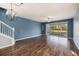 Open living room with hardwood floors and sliding glass doors leading to a screened patio at 2542 Glenrise Pl, Wesley Chapel, FL 33544