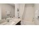 Bright bathroom featuring a bathtub with white shower curtain and quartz counter at 255 Royal Spoonbill Dr, Ruskin, FL 33570