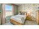 Cozy bedroom with decorative wall paper, wood frame bed and outdoor views at 255 Royal Spoonbill Dr, Ruskin, FL 33570