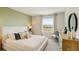 A serene bedroom with a large window, soft lighting, and neutral tones creating a peaceful retreat at 255 Royal Spoonbill Dr, Ruskin, FL 33570