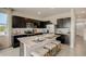 A stylish kitchen showcasing dark cabinets, stainless steel appliances, and a center island with seating at 255 Royal Spoonbill Dr, Ruskin, FL 33570
