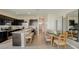 Spacious kitchen and dining area with a central island, dark cabinets, and stainless steel appliances at 255 Royal Spoonbill Dr, Ruskin, FL 33570