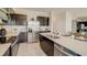 Well-appointed kitchen featuring stainless steel appliances, granite countertops, and dark cabinets in a modern design at 255 Royal Spoonbill Dr, Ruskin, FL 33570