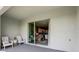 Covered patio features white outdoor seating with an indoor view to the living room at 255 Royal Spoonbill Dr, Ruskin, FL 33570