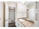 Updated bathroom featuring a walk-in shower, granite countertop, and modern fixtures at 3211 W Swann Ave # 605, Tampa, FL 33609