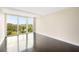 Bright bedroom featuring wood floors and a large window with a serene outdoor view at 3211 W Swann Ave # 605, Tampa, FL 33609