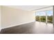 Bright and airy bedroom featuring dark hardwood floors and a sliding glass door to a balcony at 3211 W Swann Ave # 605, Tampa, FL 33609
