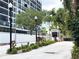 View of building entrance, gatehouse, and landscaping at 3211 W Swann Ave # 605, Tampa, FL 33609