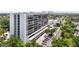 Exterior shot of a high-rise building featuring many balconies, parking, and manicured trees at 3211 W Swann Ave # 605, Tampa, FL 33609
