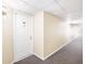Hallway with carpeting leading to unit entry door at 3211 W Swann Ave # 605, Tampa, FL 33609