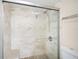 Modern tiled shower with glass enclosure and updated fixtures in renovated bathroom at 3211 W Swann Ave # 605, Tampa, FL 33609