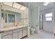 Well-lit bathroom with a single sink vanity, toilet, and a walk-in shower at 339 Club Manor Dr, Sun City Center, FL 33573