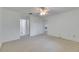 Spacious bedroom featuring neutral carpet, ceiling fan, and ample natural light from multiple entryways at 339 Club Manor Dr, Sun City Center, FL 33573
