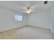Bright bedroom with soft carpet, large window, and a ceiling fan for comfort at 339 Club Manor Dr, Sun City Center, FL 33573