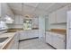 Bright kitchen features white cabinetry, light countertops and neutral tile flooring at 339 Club Manor Dr, Sun City Center, FL 33573