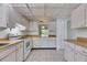 Efficient white kitchen with laminate countertops and tile flooring at 339 Club Manor Dr, Sun City Center, FL 33573
