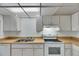 Well lit kitchen features white appliances, light countertops and neutral tile flooring at 339 Club Manor Dr, Sun City Center, FL 33573