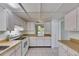 Bright kitchen features white cabinetry, light countertops and neutral tile flooring at 339 Club Manor Dr, Sun City Center, FL 33573