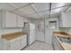 Bright kitchen features white appliances, light countertops and neutral tile flooring at 339 Club Manor Dr, Sun City Center, FL 33573