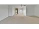 Spacious living room area featuring neutral carpet, ample lighting, and an open floorplan at 339 Club Manor Dr, Sun City Center, FL 33573