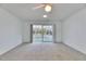 Open living room with sliding glass doors leading to an enclosed lanai at 339 Club Manor Dr, Sun City Center, FL 33573