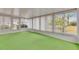 Cozy sunroom with many windows, offering scenic views of the outdoors and green carpet at 339 Club Manor Dr, Sun City Center, FL 33573