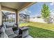 Inviting screened-in back patio with comfortable seating and views of the pool and spacious green backyard at 33922 Jasper Stone Dr, Wesley Chapel, FL 33543