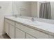 Bathroom featuring a double vanity with modern fixtures and a shower with a neutral curtain at 33922 Jasper Stone Dr, Wesley Chapel, FL 33543