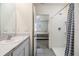 Ensuite bathroom featuring a shower, sink with modern fixtures, and a view of the bedroom at 33922 Jasper Stone Dr, Wesley Chapel, FL 33543