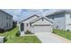 Charming single-story home featuring a two-car garage and well-maintained front lawn at 33922 Jasper Stone Dr, Wesley Chapel, FL 33543