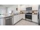 Modern kitchen featuring stainless steel appliances, white cabinets, and granite countertops at 33922 Jasper Stone Dr, Wesley Chapel, FL 33543