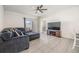 Spacious living room features a comfortable sectional sofa, tile flooring, and a ceiling fan at 33922 Jasper Stone Dr, Wesley Chapel, FL 33543