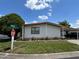 Well-maintained home with covered parking and manicured landscaping, located on a corner lot at 34300 Countryside Dr, Wesley Chapel, FL 33543