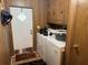 Convenient laundry room providing a washer, dryer, and ample storage space at 34300 Countryside Dr, Wesley Chapel, FL 33543