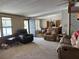 Inviting living room with comfortable seating and ample natural light from large windows at 34300 Countryside Dr, Wesley Chapel, FL 33543