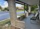 Relax on this covered porch with comfortable seating and views of the surrounding neighborhood at 34300 Countryside Dr, Wesley Chapel, FL 33543