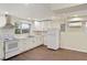 Bright kitchen features white cabinetry, stainless hood, and wood-look floors at 345 21St S Ave, St Petersburg, FL 33705