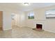 Open-concept living room with a decorative fireplace, tiled flooring, and bright windows at 345 21St S Ave, St Petersburg, FL 33705