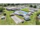 Aerial view of the community's amenities including the pool, shuffleboard and bocce ball courts at 3542 Castle Dr, Zephyrhills, FL 33540