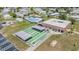 Aerial view of the shuffleboard courts, clubhouse, and swimming pool at this active community at 3542 Castle Dr, Zephyrhills, FL 33540