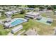 Aerial view of the community's amenities; swimming pool, shuffleboard courts, and clubhouse at 3542 Castle Dr, Zephyrhills, FL 33540