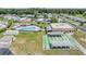 Aerial view showcases a community pool and shuffleboard courts at 3542 Castle Dr, Zephyrhills, FL 33540
