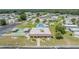 Community center aerial view showing shuffleboard, community pool, and parking area at 3542 Castle Dr, Zephyrhills, FL 33540