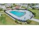 Aerial view of the community swimming pool with ample seating and a fenced-in perimeter at 3542 Castle Dr, Zephyrhills, FL 33540