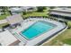 Community swimming pool with a sun deck and lounge chairs for relaxing poolside at 3542 Castle Dr, Zephyrhills, FL 33540