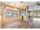 Inviting dining area featuring wood-style flooring, built-in shelving, and a charming stained glass light fixture at 3542 Castle Dr, Zephyrhills, FL 33540